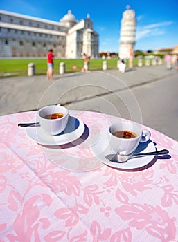 two espresso cups on a table in Pisa