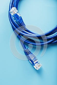 Two Ethernet Cable Connectors Patch cord cord close-up isolated on a blue background with free space