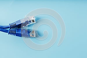 Two Ethernet Cable Connectors Patch cord cord close-up isolated on a blue background with free space