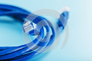 Two Ethernet Cable Connectors Patch cord cord close-up isolated on a blue background with free space