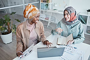 Two Ethnic Women Working in Office