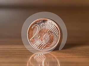 Two euro cent standing on a wodden table