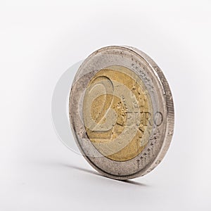 Two-euro coin standing upright on a white background