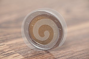 Two euro coin on a wooden surface