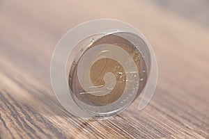 Two euro coin on a wooden surface