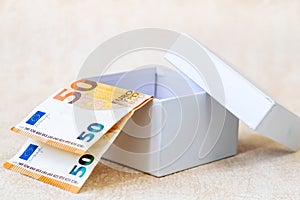 Two European Banknotes of 50 Euro in white box. Studio Shot