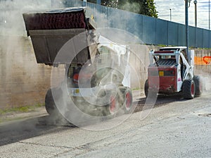 Two excavators perform milling of asphalt