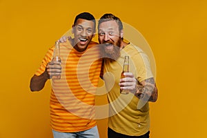 Two excited men screaming with thrill holding beer while standing isolated