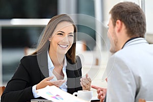 Two executives having a business conversation in a bar