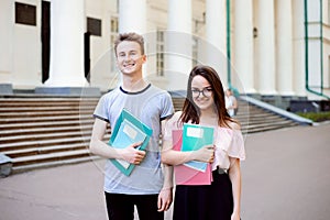 Two exemplary students in front of university