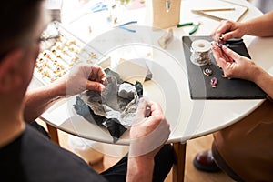 Two experienced jewelers working in their workshop