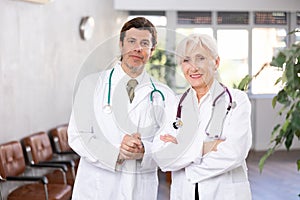 Two experienced professional doctors standing in medical office