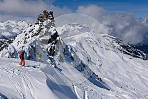 Two experienced skiers getting ready downhill off piste area at the Meribel ski resort in France.