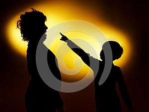 Two expressive boy's silhouettes showing emotions using gesticu