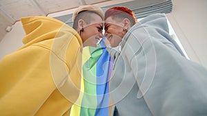 Two Exuberant Women Celebrating LGBT Pride Wrapped in a Vivid Rainbow Flag Together