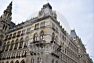 Two facades of the historic building housing the Vienna City Hall under blue skies.