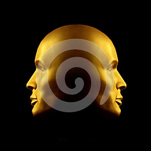 Two-faced gold head statue photo