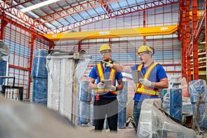 Two factory workers or technician hold tablet check and maintenance the machine in factory workplace
