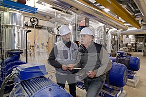 two factory workers in workshop
