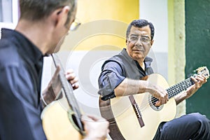 Two fado guitarists with acoustic and portuguese guitars