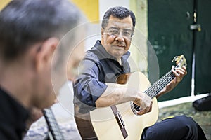 Two fado guitarists with acoustic and portuguese guitars