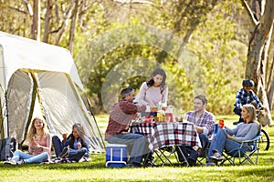 Two Families Enjoying Camping Holiday In Countryside