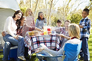 Two Families Enjoying Camping Holiday In Countryside