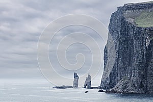 Two famous sea stacks Risin og Kellingin - the Giant and his Wife in the Faroe Islands.  View from village Tjornuvik on Streymoy