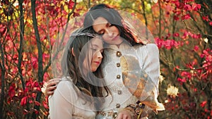 Two fantasy women walking in forest with barn owl white bird sits on hand, young mother and adult daughter teen. Vintage