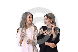 Two fashion model girls black and white formal closes smiling