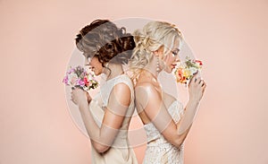 Two Fashion Models with Flowers Bouquet Beauty Portrait, Beautiful Women Studio Shot on beige