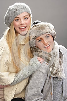 Two Fashionable Teenage Girls Wearing Knitwear photo