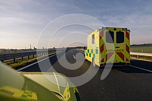 Two fast moving ambulance cars of emergency medical service