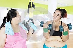 Two fat women in the fitness center