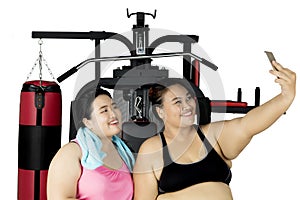 Two fat women taking selfie after exercise