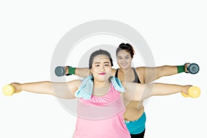 Two fat women training with dumbbells