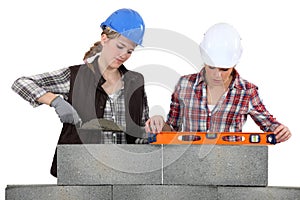 Two female bricklayers