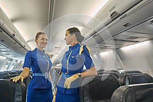 Two female cabin crew members waiting for the passengers