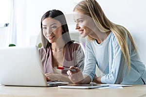 Two female colleagues in office working together.