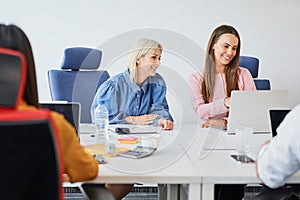 Two female colleagues working together in coworking office