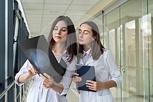 Two female doctors discusses the results of X-ray scan