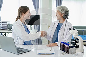 Two female doctors holding hands in hospital, holding hands, unity and teamwork They feel happy