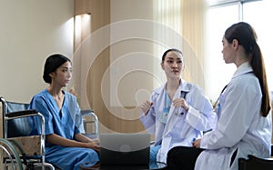 Two female doctors at an international hospital giving advice to convalescent patients photo