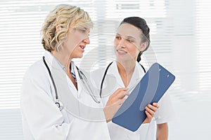 Two female doctors reading medical reports