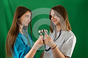 two female doctors standing back to back with crossed arms isolated on a certain background.