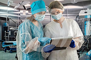 Two female doctors are talking in the clinic of surgery and dentistry.