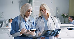 Two female doctors working together 4k