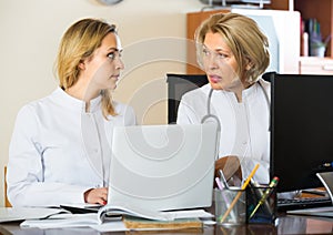 Two female doctors working together