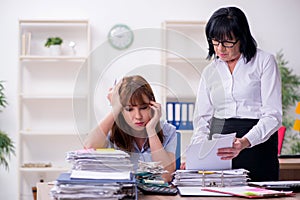 Two female employees and excessive work in the office