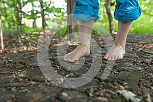 Two female feet go over wooden discs